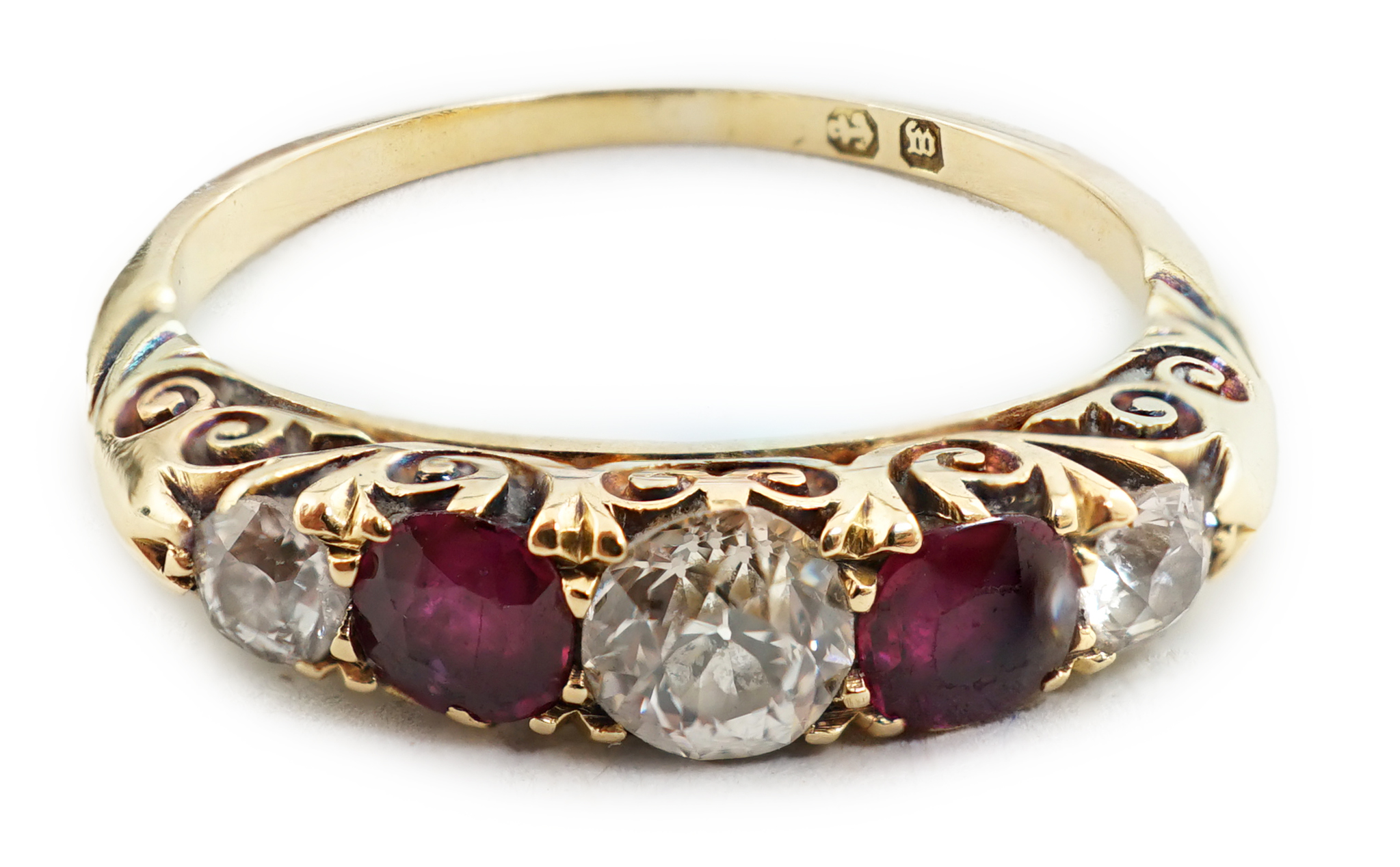 A late Victorian gold, three stone diamond and two stone ruby set half hoop ring
